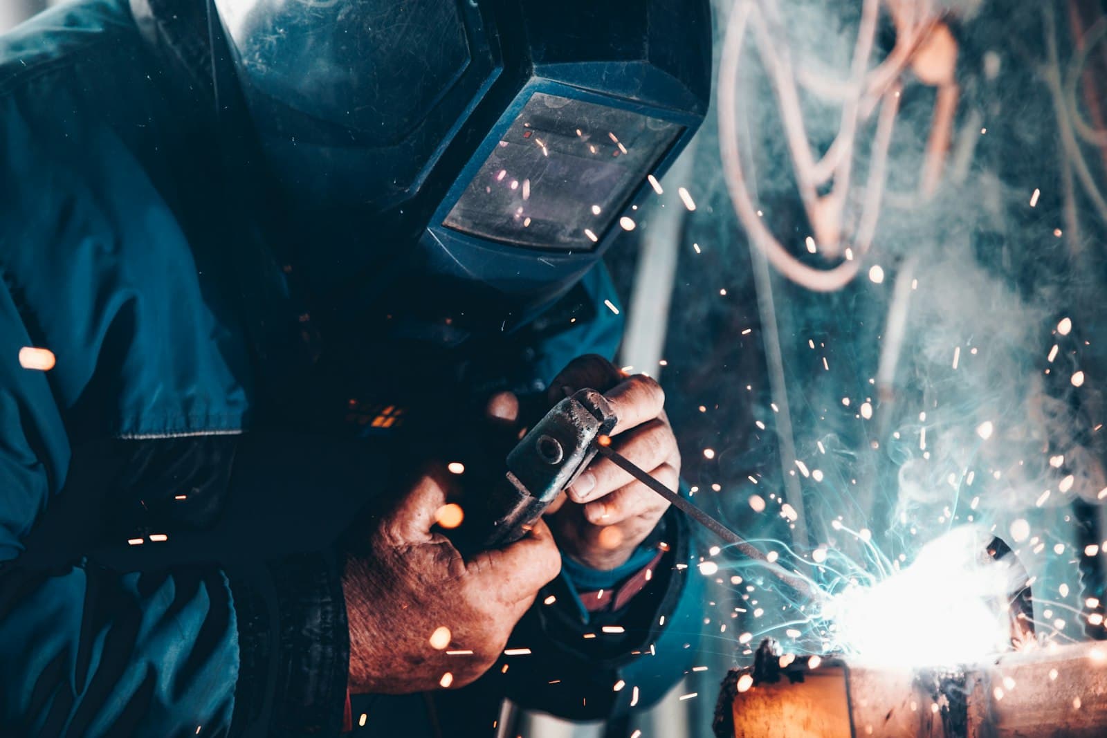 Welder striking an arc on structural steel